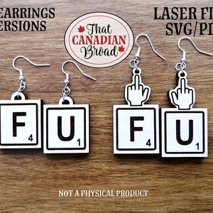 May include: Two pairs of earrings with a white background and black lettering. One pair features the letters "F" and "U" from a Scrabble game. The other pair features a middle finger with the letters "F" and "U" below it.