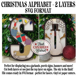 May include: Two-layer SVG cut files for the letters "S" and "O" in a Christmas theme. The "S" features a sleigh, presents, and lights, while the "O" has a snowman and snowflakes. The text "That Canadian Broad" is visible in the image.