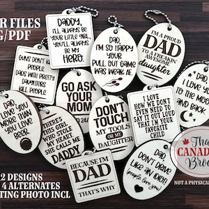 May include: Twelve laser cut wooden tags with various sayings about dads and daughters. The tags are oval and rectangular shaped and have a brown wood grain finish. The text is in black and white. The tags are arranged in a random pattern on a wooden surface.