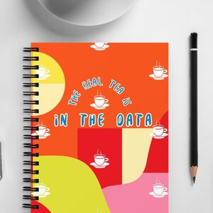 May include: A spiral bound notebook with a colorful abstract design featuring a repeating pattern of teacups and the text "The real tea is in the data".