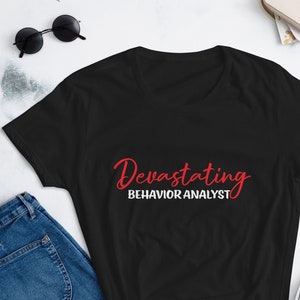 May include: Black t-shirt with the text "Devastating Behavior Analyst" in red lettering.