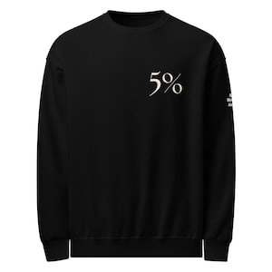 May include: Black sweatshirt with the number "5%" in an off-white script on the upper left chest. The right sleeve has the text "BEHIND AN". The sweatshirt has a crew neck and long sleeves.