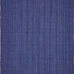 May include: A solid blue rug made of woven jute fibers. The rug has a subtle texture and a slightly distressed look.