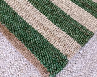 May include: A green and natural jute rug with a striped pattern. The rug is woven with thick, natural fibers.