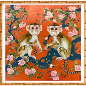 May include: Two monkeys with brown and white fur sit on a blue and gold tree branch with pink flowers. The background is a bright orange colour.