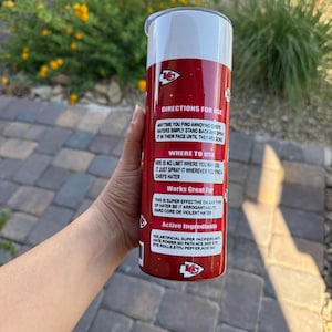 May include: A red and white insulated tumbler with text that reads "DIRECTIONS FOR USE" and "Works Great For". The tumbler has a silver lid and features the Kansas City Chiefs logo.
