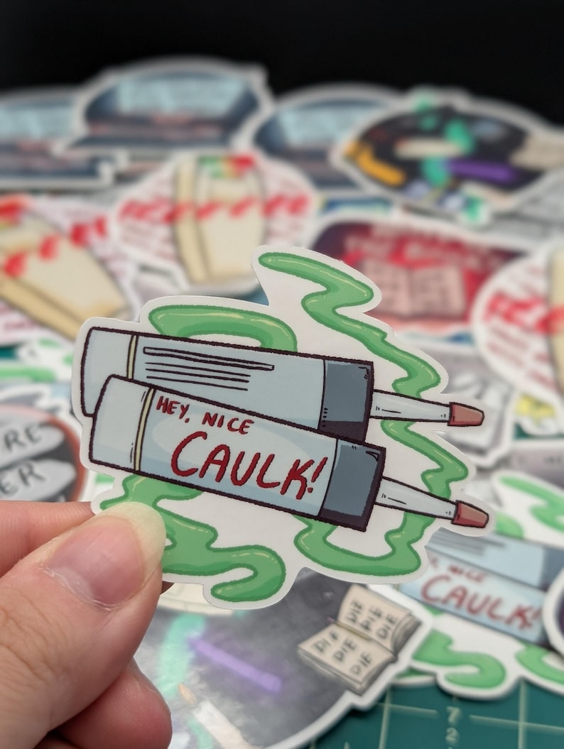 May include: A sticker with a cartoon image of two tubes of caulk with green goo coming out of them. The text on the sticker says "Hey, nice caulk!"