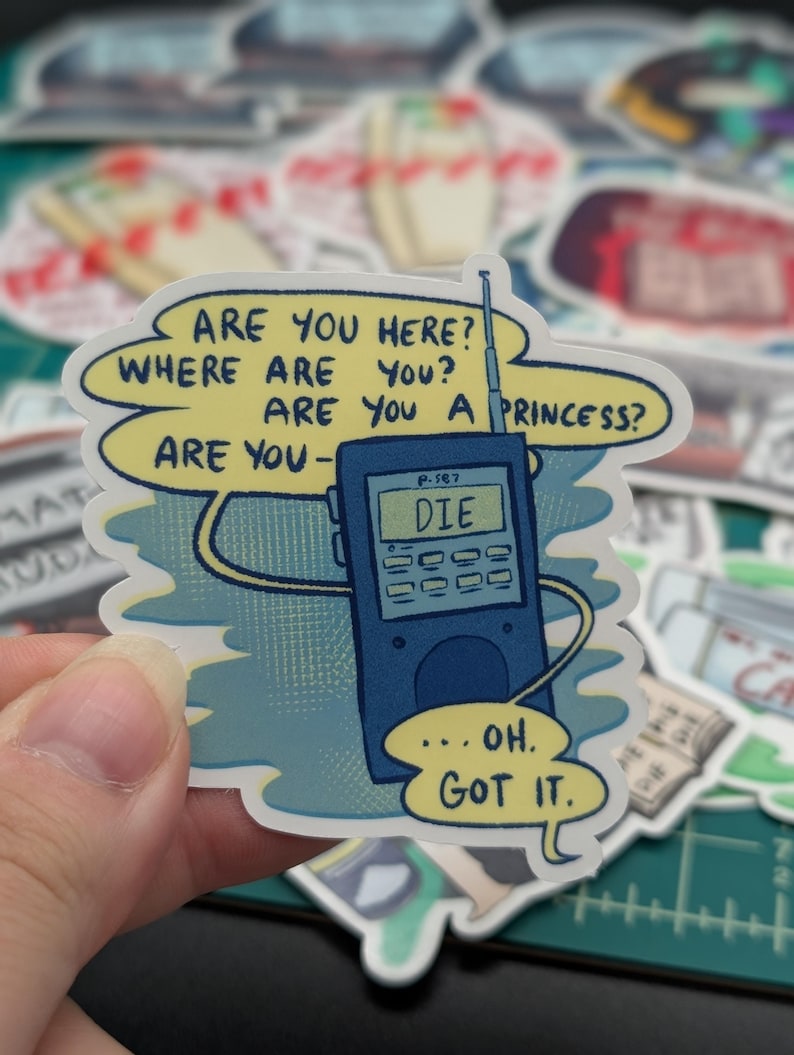 May include: A blue and white sticker with a cartoon illustration of a walkie-talkie with the text "ARE YOU HERE? WHERE ARE YOU? ARE YOU A PRINCESS? ARE YOU- DIE ...OH. GOT IT."