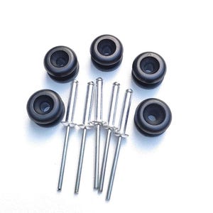 May include: A set of six black rubber grommets with silver metal rivets. The grommets are designed to protect fabric edges from fraying and wear.