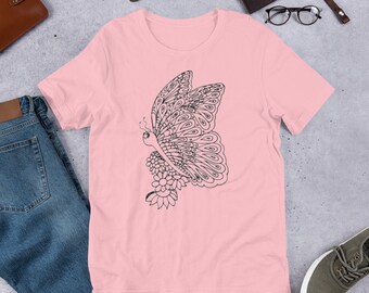 May include: A pink short-sleeved t-shirt with a black and white butterfly design. The butterfly is detailed with intricate patterns and is positioned on the left side of the shirt.