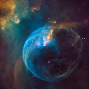 May include: A vibrant nebula with a large, blue, glowing sphere at its centre. The sphere is surrounded by a swirling cloud of gas and dust, with a bright star shining in the centre. The nebula is a beautiful example of the vastness and beauty of space.