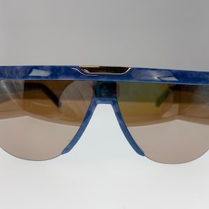 Vintage sunglasses by Silhouette model M 3100. Blue vintage shield sunglasses from the 80s. Blue frame sunglassses with brown lenses.