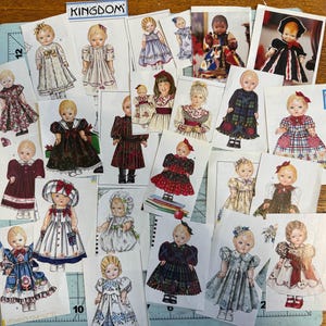 May include: A collection of paper doll cutouts featuring various dolls in diverse dresses and outfits. The images include illustrations and photographs of dolls with different hairstyles, hair colors, and clothing patterns. The word KINGDOM is printed at the top.