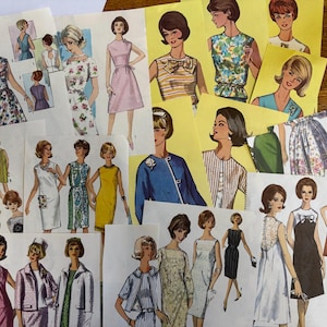 May include: A collection of vintage sewing pattern illustrations featuring various mid-century dress styles, including floral prints, solid colors, and textured fabrics, displayed on paper sheets with detailed sketches of garments and figures.