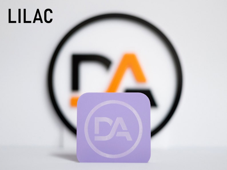 May include: A lilac square business card with a white circle and the letters "DA" inside the circle.