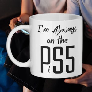 May include: White ceramic mug with a black inscription that reads "I'm Always on the PS5".
