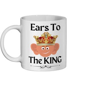 Cartoon king Charles with big ears on an 11oz ceramic mug, showcasing a playful and colorful royal design with a detailed crown and a friendly face and the text 'Ears to the King'