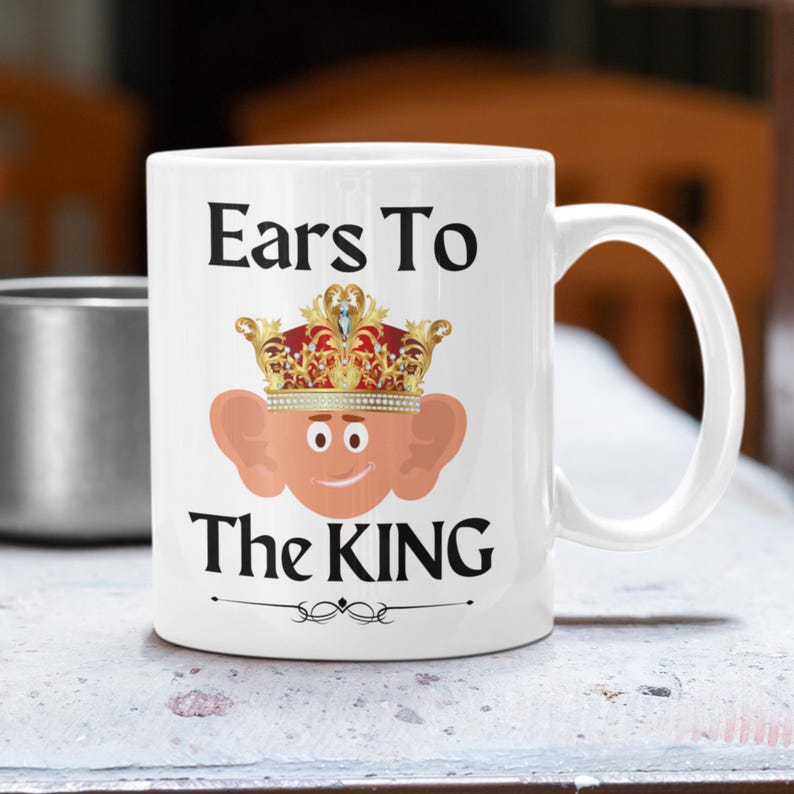 Unique ceramic coffee mug, 11oz, with a cute cartoon king Charles character with large ears and a golden crown, with the text ' Ears to the King' ideal for fans of the royal family, monarchy and humorous gifts
