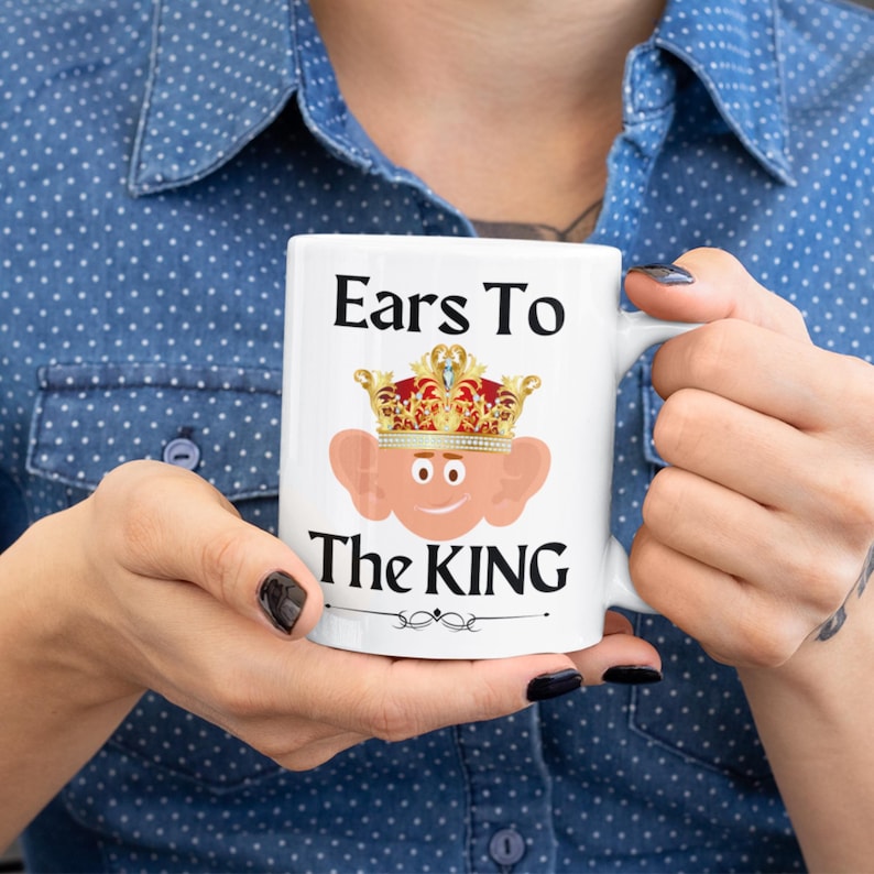 Unique ceramic coffee mug, 11oz, with a cute cartoon king Charles character with large ears and a golden crown, ideal for fans of quirky and humorous mugs. The text is 'Ears to the King' A great royal gift!