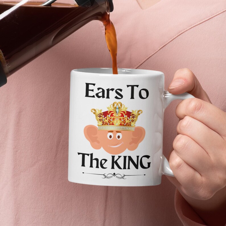 Unique ceramic coffee mug, 11oz, with a cute cartoon king Charles character with large ears and a golden crown, with the text ' Ears to the King' ideal for fans of the royal family, monarchy and humorous gifts