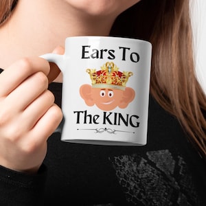 Unique ceramic coffee mug, 11oz, with a cute cartoon king Charles character with large ears and a golden crown, with the text ' Ears to the King' ideal for fans of the royal family, monarchy and humorous gifts