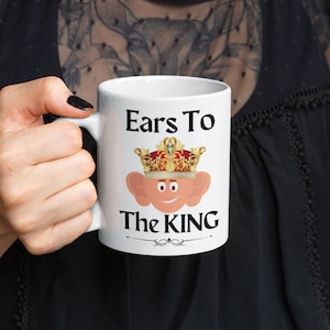 Funny 11oz mug with a cartoon illustration of  king Charles with oversized ears and a royal crown, perfect for adding humor to your morning coffee. Ears to the King