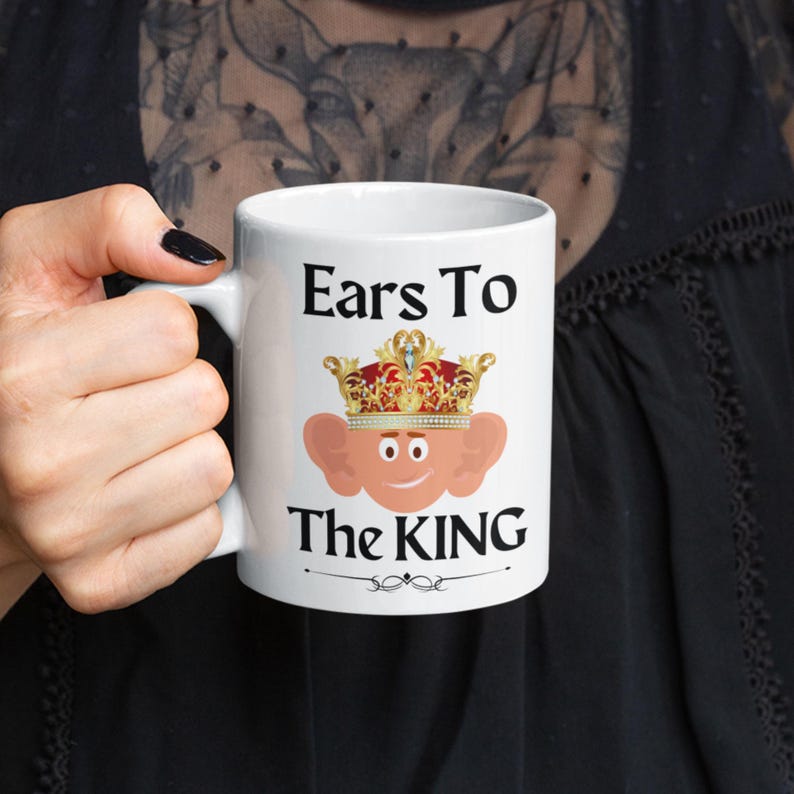 Funny 11oz mug with a cartoon illustration of  king Charles with oversized ears and a royal crown, perfect for adding humor to your morning coffee. Ears to the King