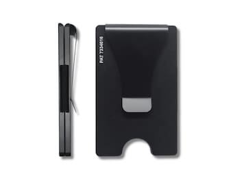 May include: A black metal card holder with a money clip. The clip has a silver finish and the card holder has the text "PAT 7334616" printed on it.