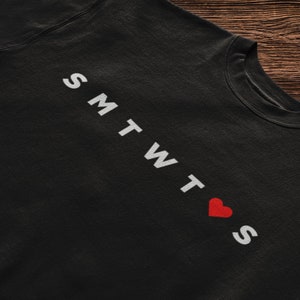 May include: Black sweatshirt with white text that reads "SMTWT❤S".