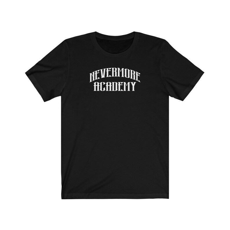 May include: Black short-sleeved t-shirt with a white graphic print that reads "NEVERMORE ACADEMY" in a gothic font.
