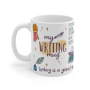 May include: White ceramic mug with a colorful design featuring the text "my writing mug today is a great day". The design includes a pen, a typewriter, a bottle of ink, and a star.