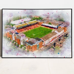 May include: A watercolour painting of a football stadium with red and yellow seats, a green pitch, and surrounding buildings. The painting has a watercolour splatter effect.