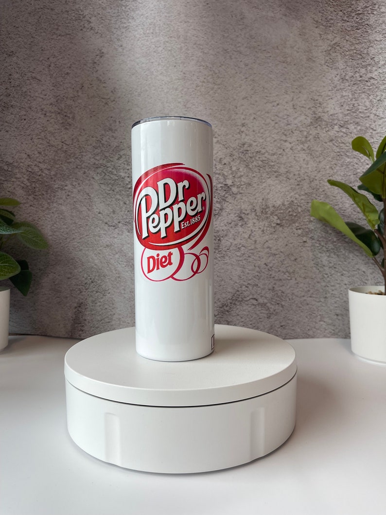 May include: White stainless steel tumbler with a red and white Dr Pepper logo and the words "Diet" and "Est. 1885".