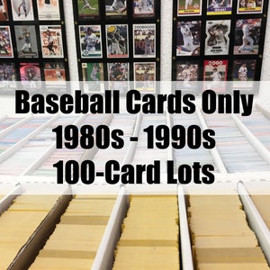 May include: A close-up of a collection of baseball cards organized in rows. The cards are in clear plastic sleeves and are stored in white boxes. The sign above the boxes reads "Baseball Cards Only 1980s - 1990s 100-Card Lots".