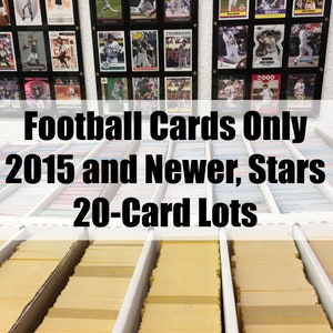May include: A collection of football trading cards organized in rows of yellow boxes. The sign above reads "Football Cards Only 2015 and Newer, Stars 20-Card Lots".