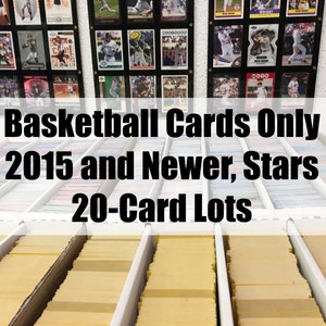 May include: A close-up of a shelf filled with rows of yellow card boxes. The boxes are labeled "Basketball Cards Only 2015 and Newer, Stars 20-Card Lots".