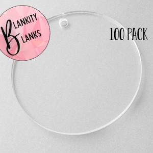 May include: A pack of 100 clear round acrylic blanks with a hole at the top. The blanks are 5 cm in diameter and are perfect for crafting.