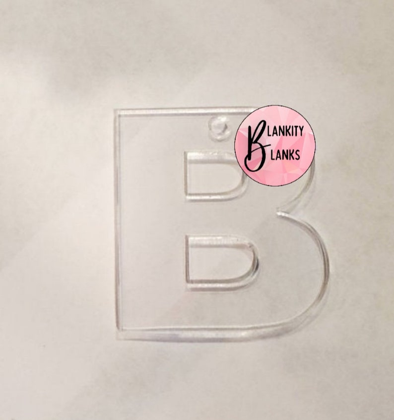 May include: Clear acrylic letter B cutout. The letter is in a simple, bold font. The cutout is ideal for crafting projects.