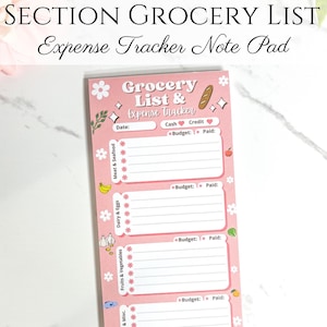 May include: A pink grocery list and expense tracker notepad with the text "Grocery List & Expense Tracker." The notepad is divided into sections for meat, dairy, fruits, and pantry items. It includes spaces for dates, budget, and paid amounts.