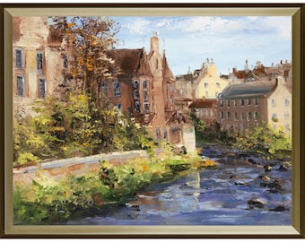May include: An oil painting in a gold frame depicting a river flowing past stone buildings and lush green foliage. The scene features brown and tan architecture under a light blue sky, with visible brushstrokes capturing the water's movement.