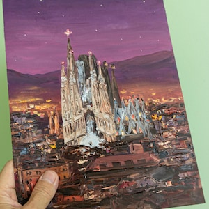 May include: An oil painting on a rectangular canvas depicting the Sagrada Familia at twilight. The scene features the cathedral's spires against a deep purple sky with stars, overlooking a city landscape rendered in dark brown, orange, and yellow.