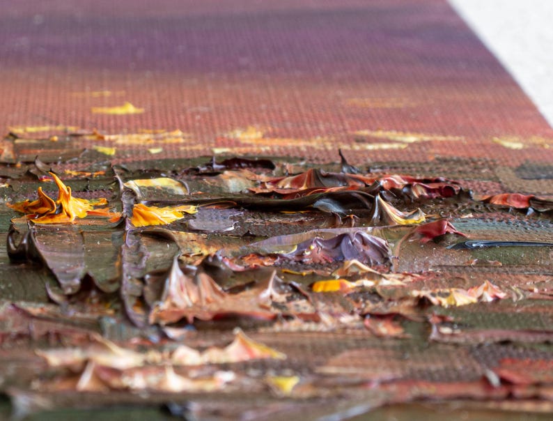May include: An oil painting on canvas featuring a textured impasto technique with thick, raised layers of paint. The color palette includes deep shades of brown, dark red, and black, accented by vibrant streaks of bright yellow and orange paint.