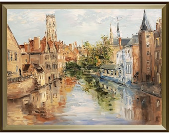 May include: An oil painting in a gold frame depicting a canal scene with historic buildings, a tall tower, and trees. The water reflects the structures in shades of brown, blue, and white, with visible brushstrokes creating a textured appearance.