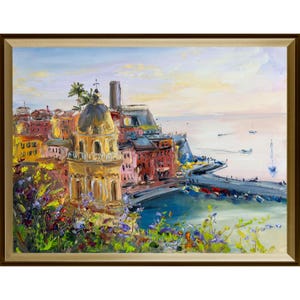 The village of Vernazza in the Cinque Terre National Park in Italy and a view of the Gulf of Genoa with yachts.