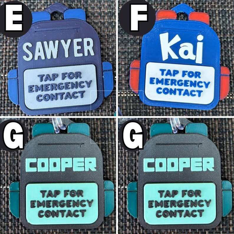 May include: A collection of backpack-shaped luggage tags in blue, red, and gray. Each tag features a name: "Sawyer", "Kai", or "Cooper", and the text "TAP FOR EMERGENCY CONTACT". The tags have a loop for attachment.