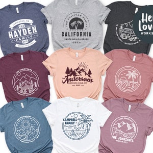 May include: Ten different t-shirt designs featuring a variety of family reunion themes. Each design includes a circle with a unique graphic and text that includes the family name, location, and year. The designs are printed on different colored t-shirts, including heather grey, navy blue, maroon, peach, and pink.