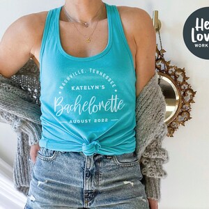 May include: A turquoise tank top with a white circle graphic that says "Nashville, Tennessee, Katelyn's Bachelorette, August 2022".
