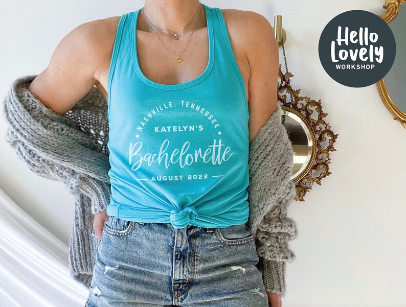 May include: A turquoise tank top with a white circle graphic that says "Nashville, Tennessee, Katelyn's Bachelorette, August 2022".