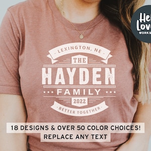 May include: A mauve t-shirt with a white graphic design that says "Lexington, NE - The Hayden Family - 2022 - Better Together -"
