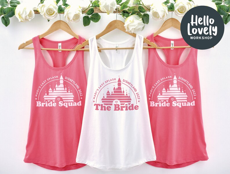 May include: Three pink and white tank tops with a graphic of Cinderella's castle and the text "Madi's Last Splash Disneyland 2022" on each. One tank top says "The Bride" and the other two say "Bride Squad".